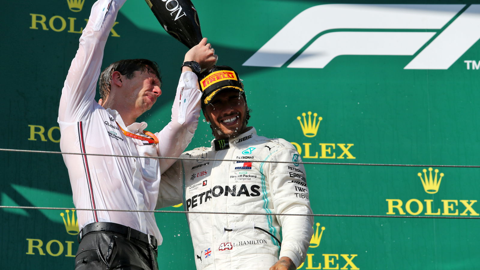 James Vowles and Lewis Hamilton celebrate on the podium. 