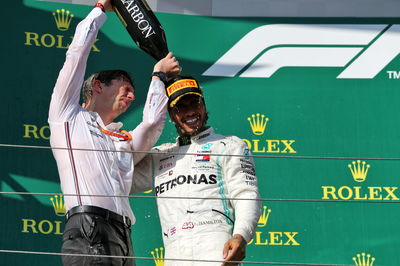 James Vowles and Lewis Hamilton celebrate on the podium. 