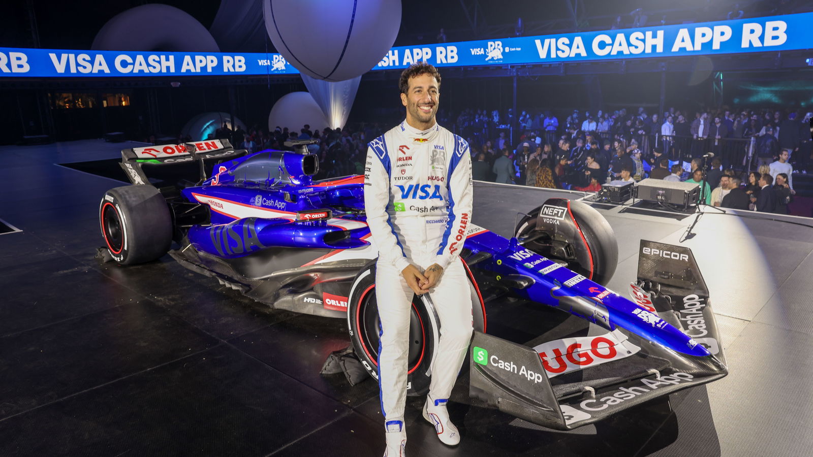 Daniel Ricciardo sitting on the new RB F1 car at their car launch in Las Vegas