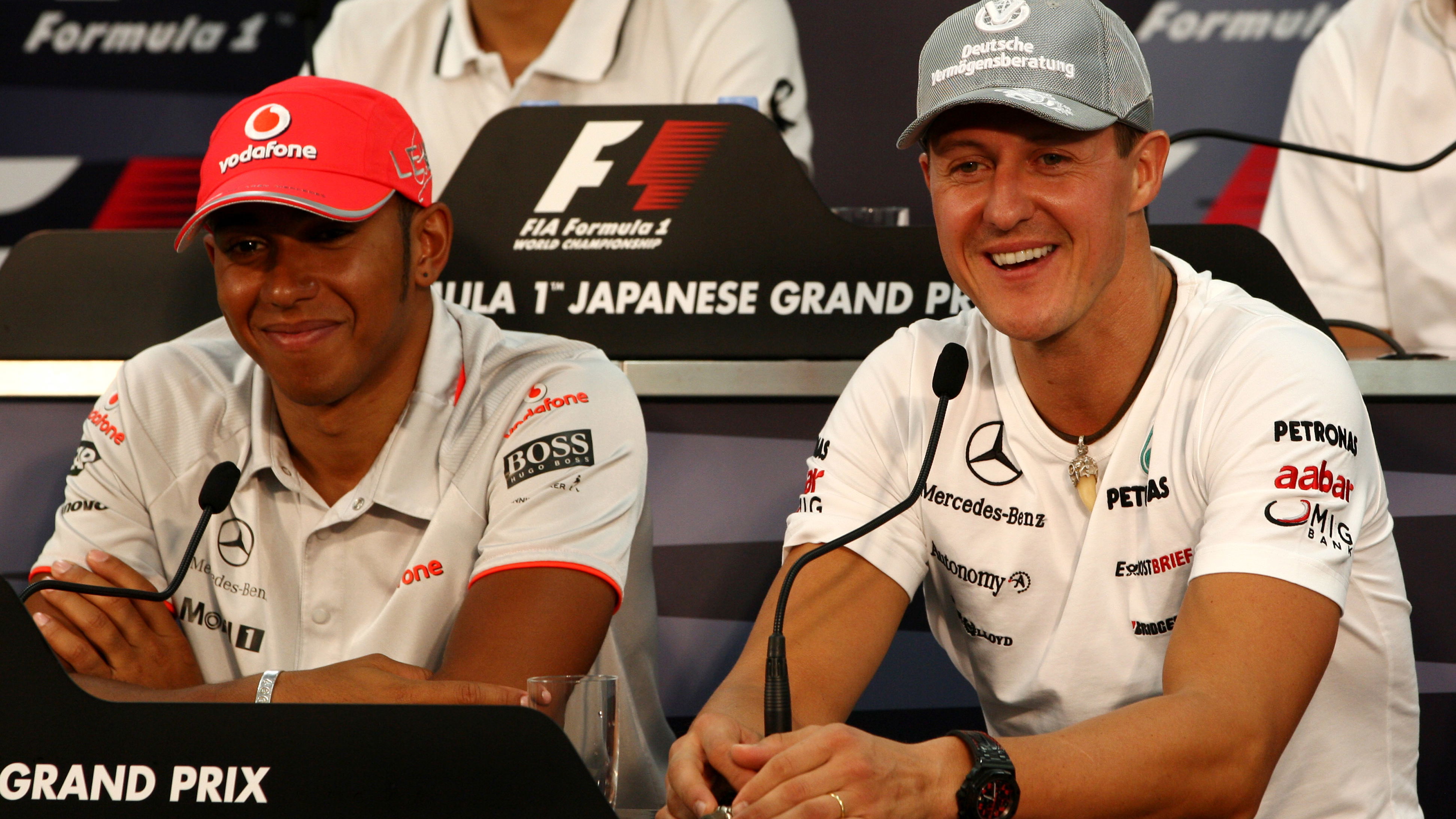 Lewis Hamilton and Michael Schumacher at the 2010 Japanese Grand Prix.