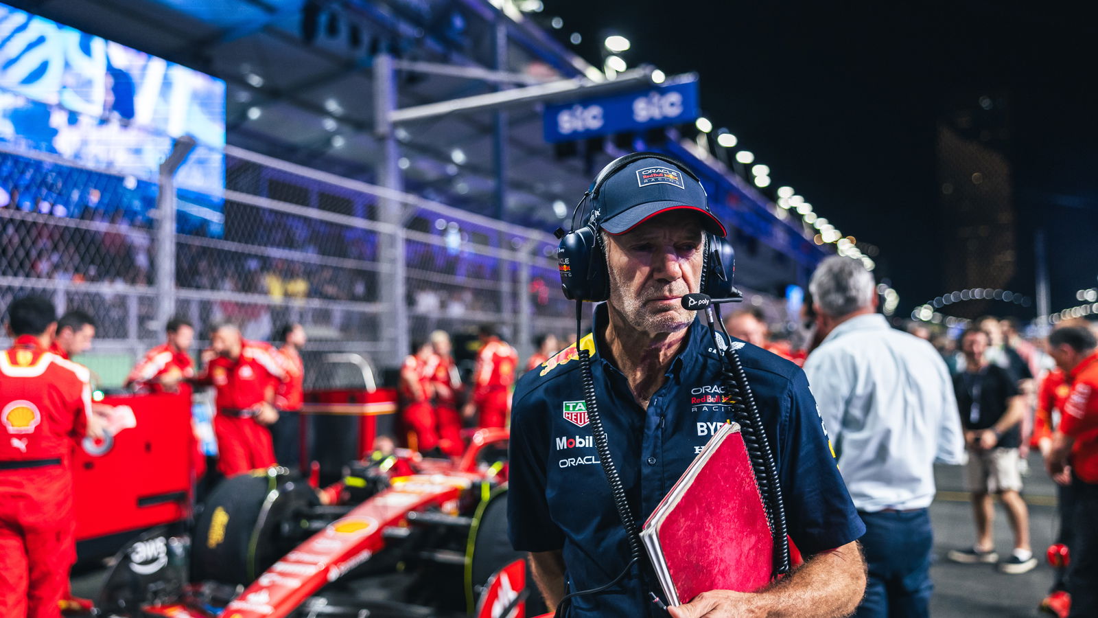 Adrian Newey stands next to Ferrari's F1 car