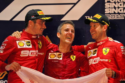 Inaki Rueda stands between Charles Leclerc and Sebastian Vettel