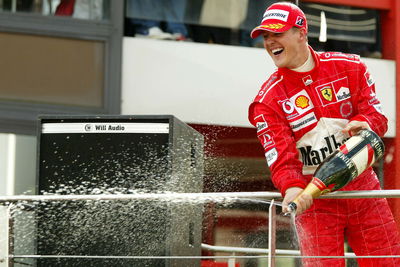 Michael Schumacher celebrates winning his seventh drivers' title in 2004