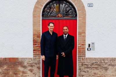 John Elkann alongside Lewis Hamilton 