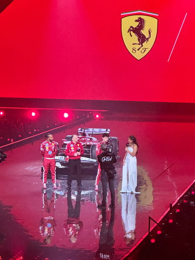 Lewis Hamilton in front of his Ferrari