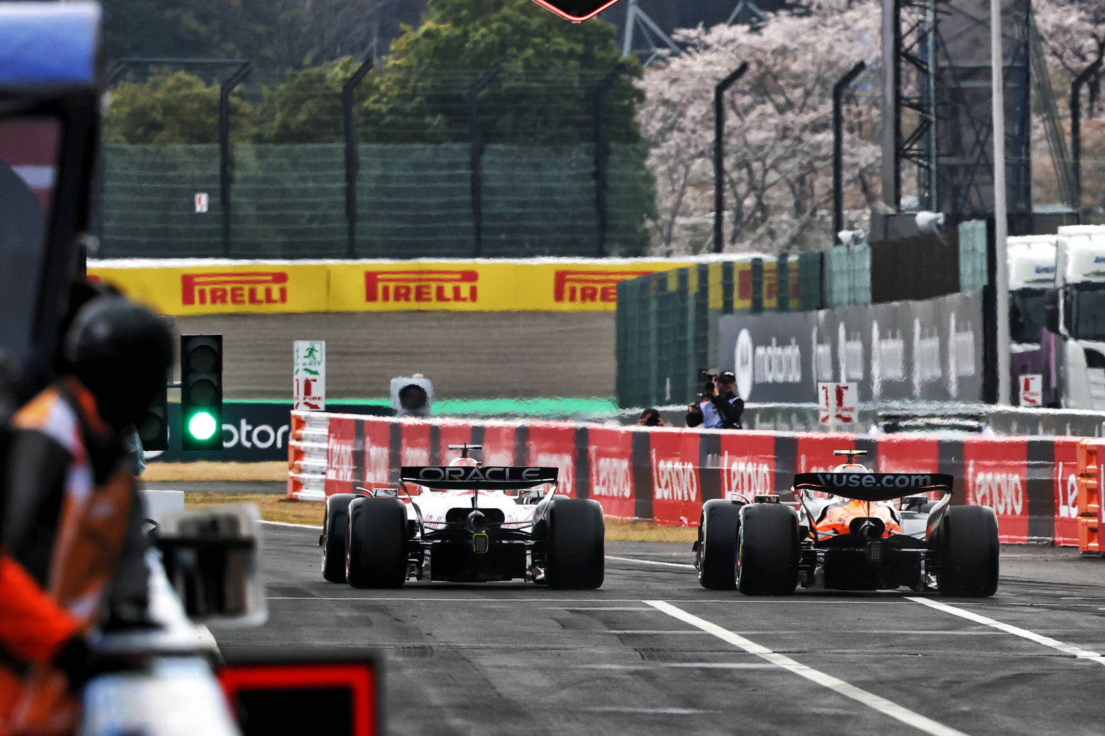 Max Verstappen and Lando Norris leave the pit lane 