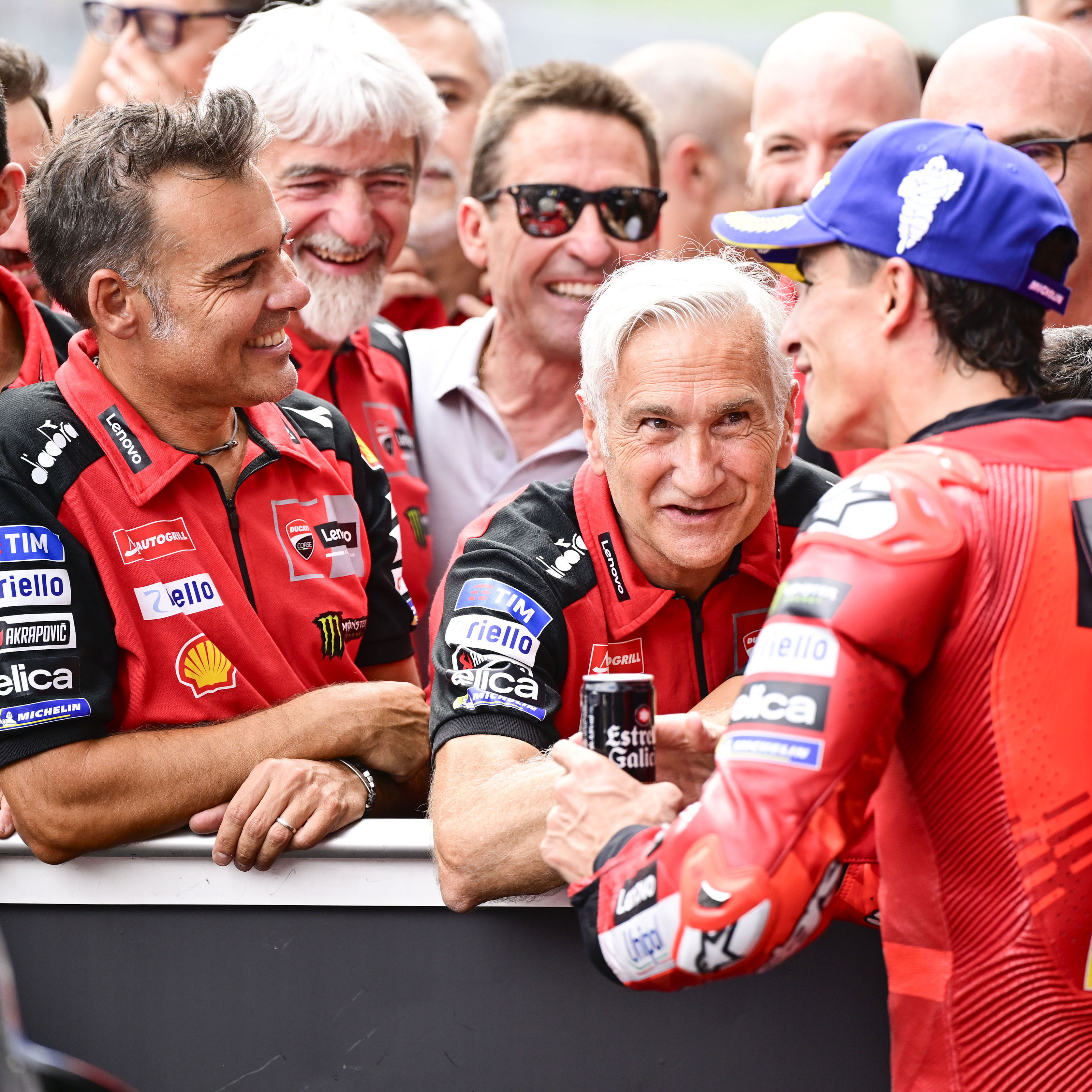Marc Marquez speaks with Davide Tardozzi, Marco Rigamonti, 2025 MotoGP Austrian Grand Prix, parc ferme. Credit: Gold and Goose.