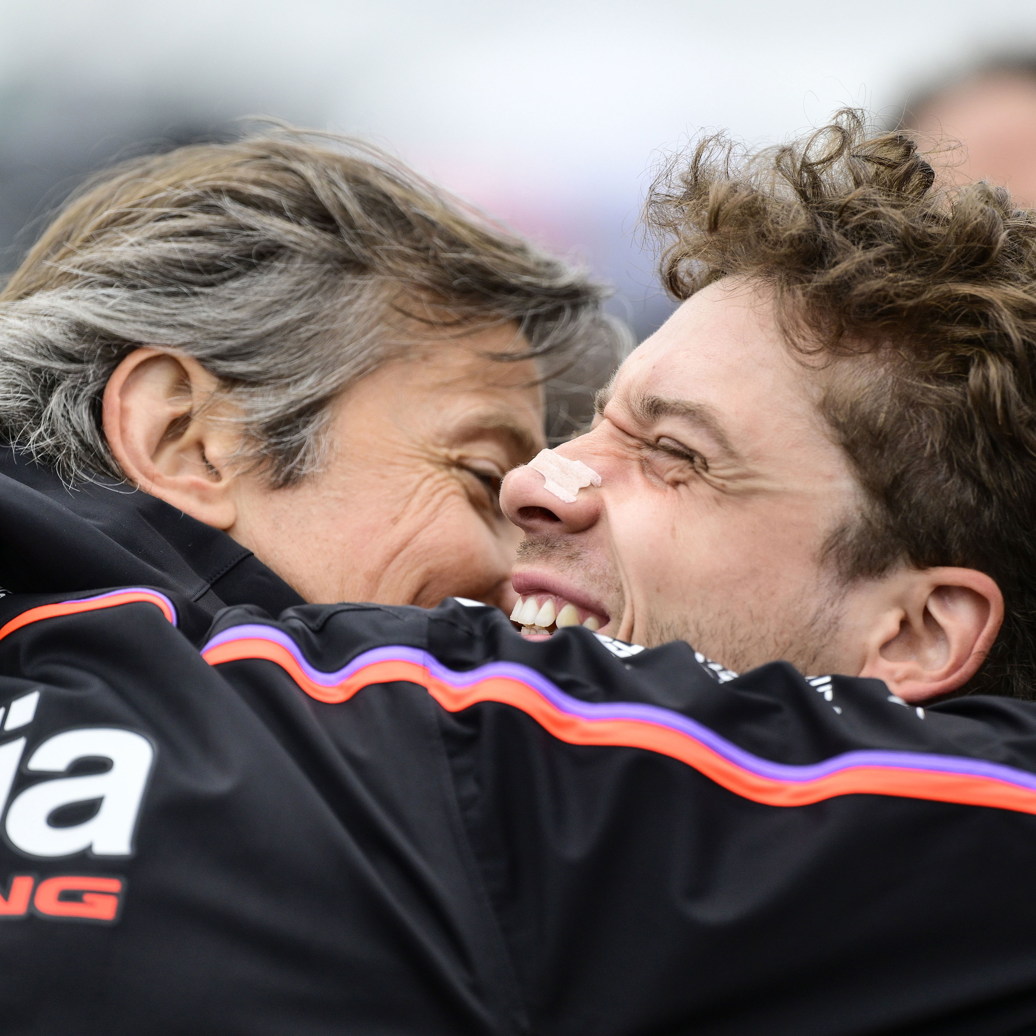 Massimo Rivola and Marco Bezzecchi embrace, 2025 MotoGP Valencia Grand Prix, Sprint post-race. Credit: Gold and Goose.
