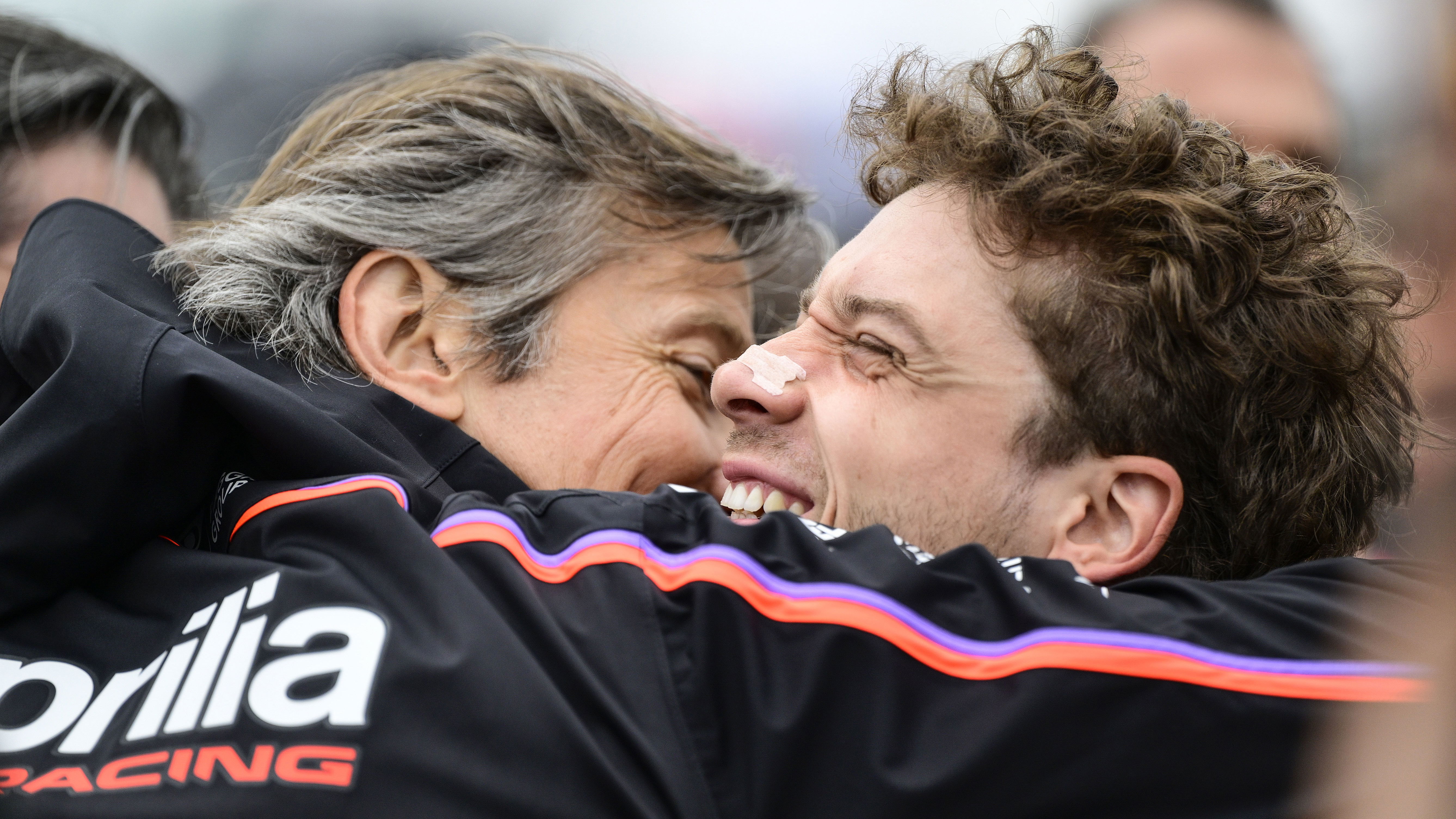 Massimo Rivola and Marco Bezzecchi embrace, 2025 MotoGP Valencia Grand Prix, Sprint post-race. Credit: Gold and Goose.