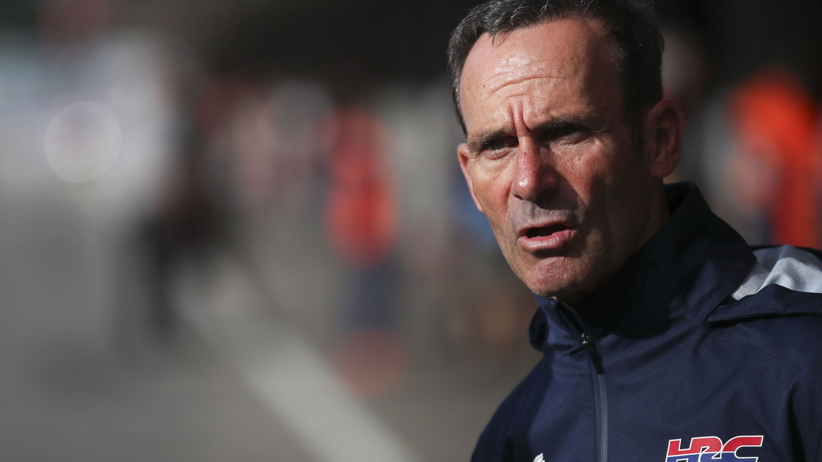 Alberto Puig, 2025 MotoGP Portuguese Grand Prix, pit lane. Credit: Gold and Goose.