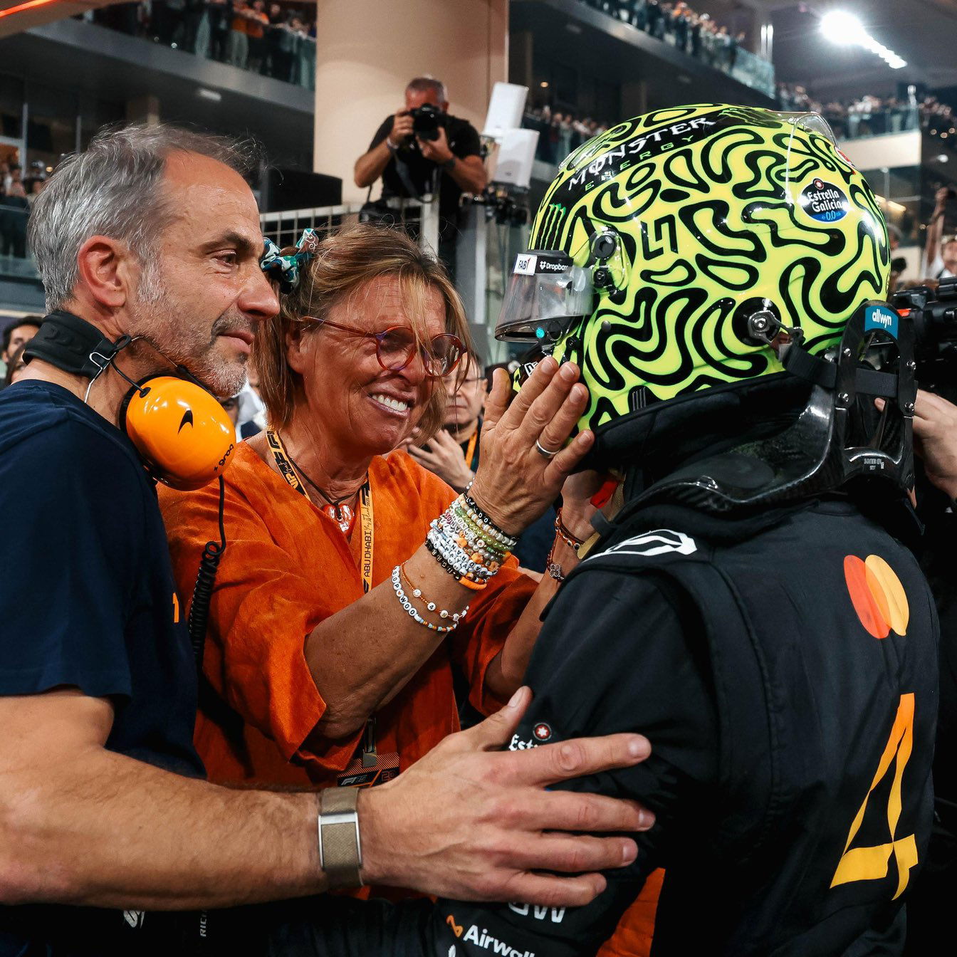 Norris celebrates with his parents