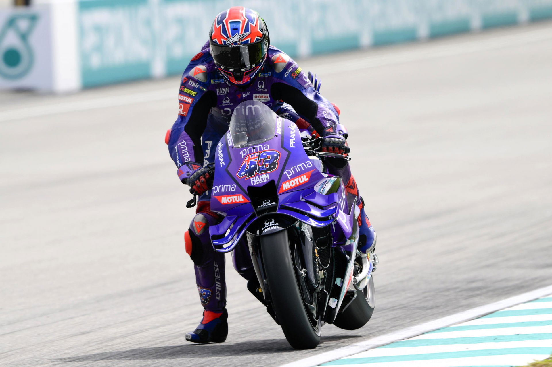 Jack Miller brakes on his inline M1 and lifts the rear wheel into the air.