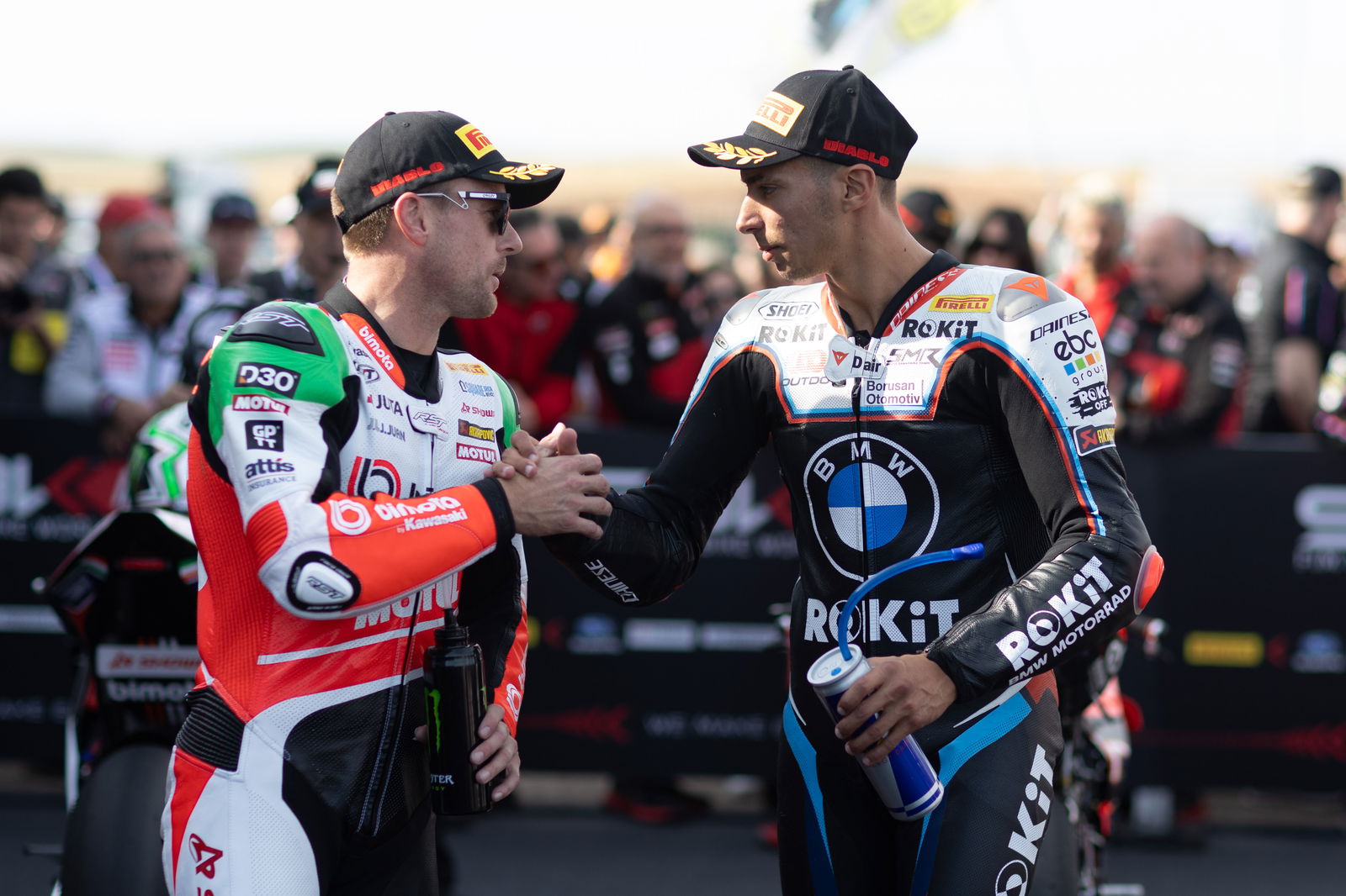 Alex Lowes and Toprak Razgatlioglu in parc ferme at 2025 French WorldSBK. Credit: Gold and Goose.