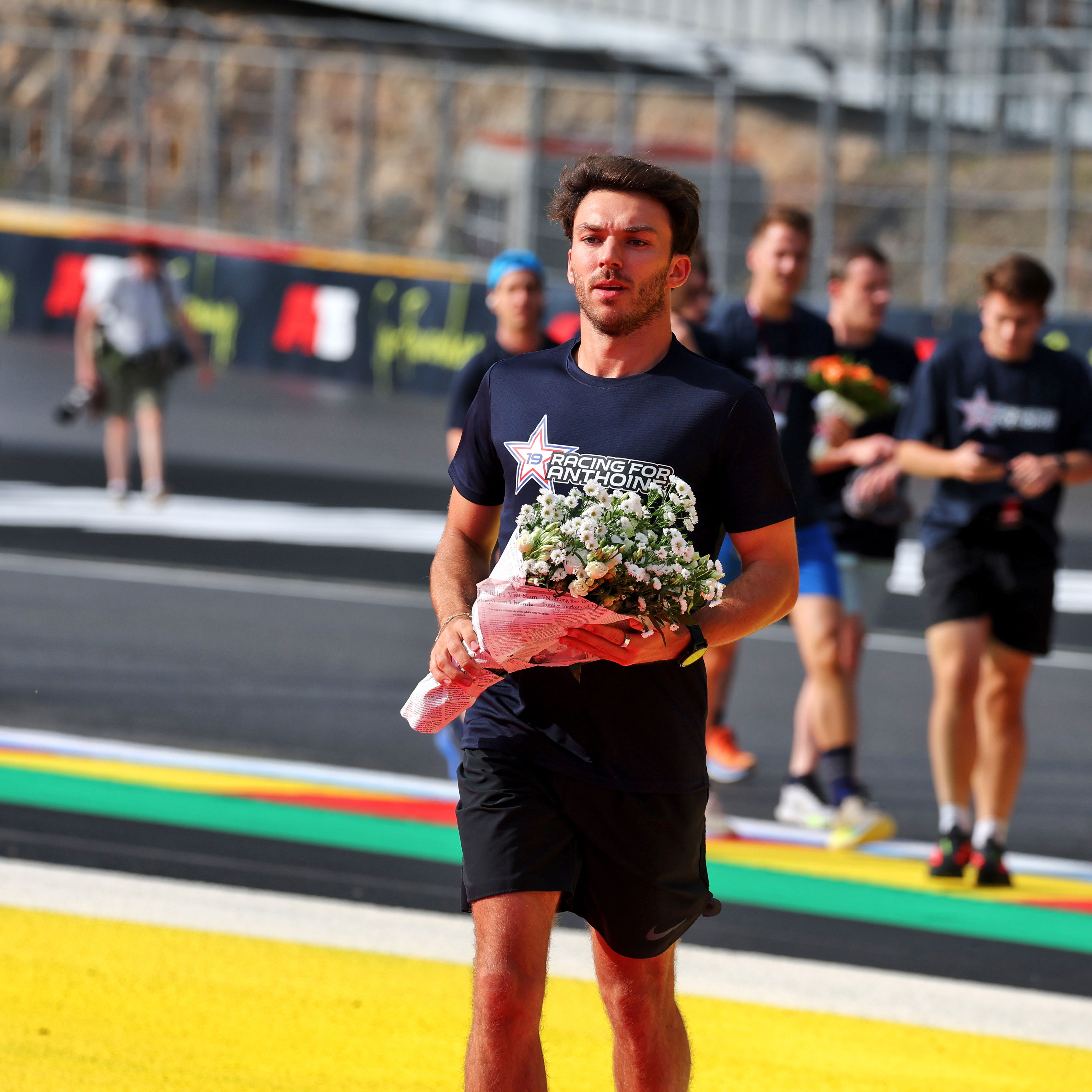 Gasly lays flowers in the now annual 'Run for Anthoine' 