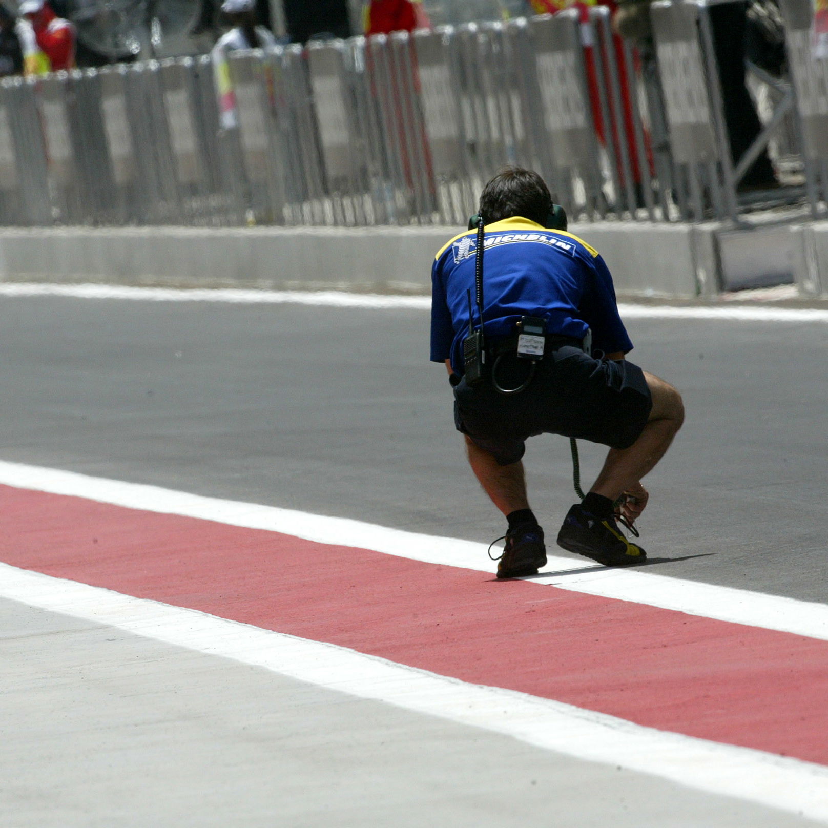A Michelin tyre technician checks the track temperature in Bahrain