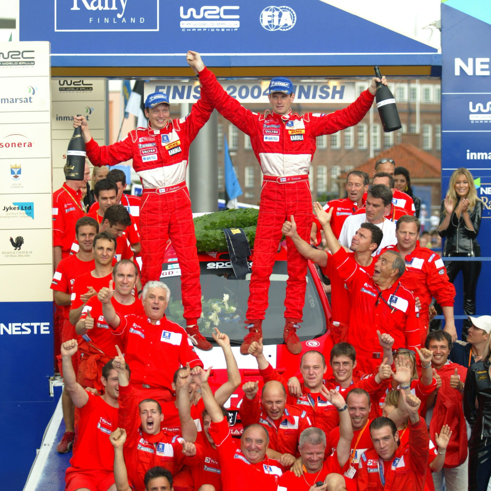 Marcus Gronholm and co-driver Timo Rautianen celebrate their Rally Finland win with the rest of the