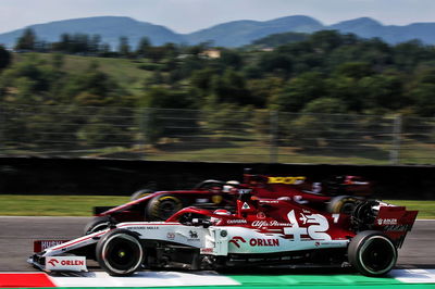 Kimi Raikkonen (FIN) Alfa Romeo Racing C39 and Sebastian Vettel (GER) Ferrari SF1000.