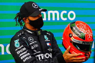 Race winner Lewis Hamilton (GBR) Mercedes AMG F1 is presented with the helmet of Michael Schumacher (GER) in parc ferme after equalling the record for the number of F1 victories.