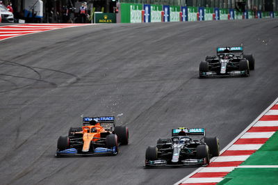 (L to R): Carlos Sainz Jr (ESP) McLaren MCL35 and Valtteri Bottas (FIN) Mercedes AMG F1 W11 battle for the lead of the race.