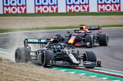 Valtteri Bottas (FIN) Mercedes AMG F1 W11 runs wide ahead of Max Verstappen (NLD) Red Bull Racing RB16.