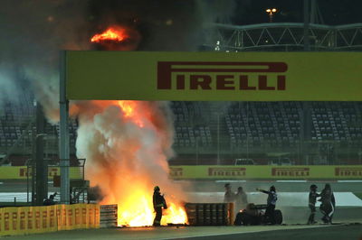 Romain Grosjean (FRA) is pulled clear of his burning Haas VF-20 by Dr Ian Roberts (GBR) FIA Doctor at the start of the race.