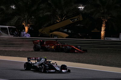 Sebastian Vettel (GER) Ferrari SF1000 recovers back to the circuit with Kevin Magnussen (DEN) Haas VF-20 passing.