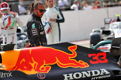 Lewis Hamilton (GBR) Mercedes AMG F1 looks at the Red Bull Racing RB16B.