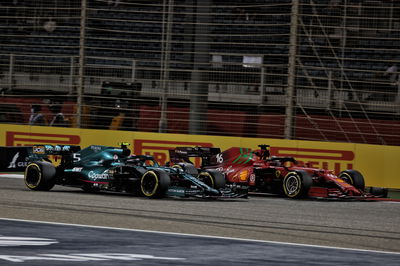 Sebastian Vettel (GER) Aston Martin F1 Team AMR21 and Charles Leclerc (MON) Ferrari SF-21 battle for position.