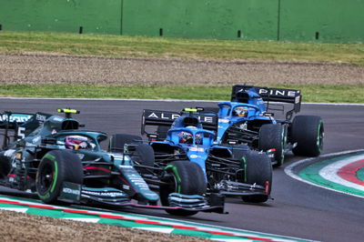 Esteban Ocon (FRA) Alpine F1 Team A521 passes Sebastian Vettel (GER) Aston Martin F1 Team AMR21.