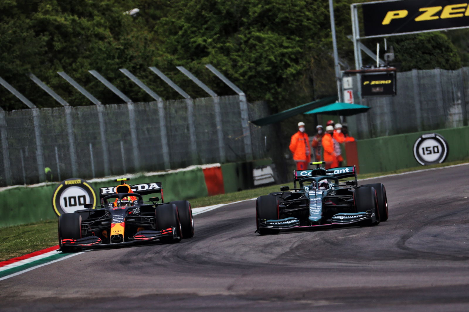 (L to R): Sergio Perez (MEX) Red Bull Racing RB16B and Sebastian Vettel (GER) Aston Martin F1 Team AMR21 battle for position.