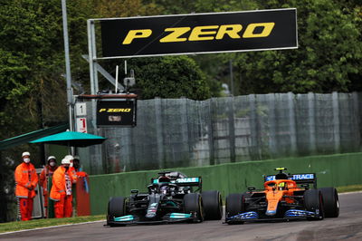 (L to R): Lewis Hamilton (GBR) Mercedes AMG F1 W12 and Lando Norris (GBR) McLaren MCL35M battle for position.