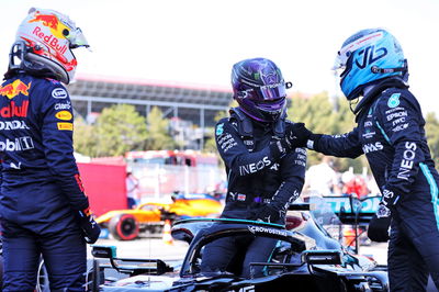 Lewis Hamilton (GBR) Mercedes AMG F1 W12 (Centre) celebrates his 100th pole position in qualifying parc ferme with team mate Valtteri Bottas (FIN) Mercedes AMG F1 (Right) and Max Verstappen (NLD) Red Bull Racing (Left).