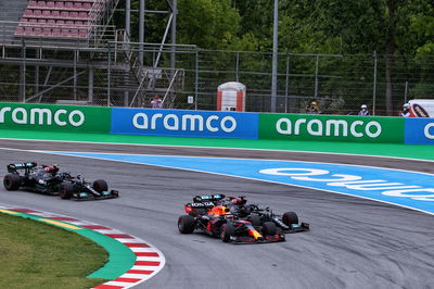 Max Verstappen (NLD) Red Bull Racing RB16B passes Lewis Hamilton (GBR) Mercedes AMG F1 W12 at the start of the race.