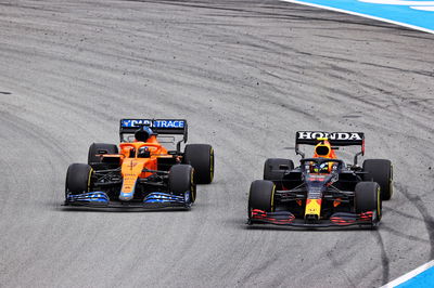 Daniel Ricciardo (AUS) McLaren MCL35M and Sergio Perez (MEX) Red Bull Racing RB16B battle for position.