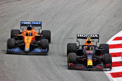 Daniel Ricciardo (AUS) McLaren MCL35M and Sergio Perez (MEX) Red Bull Racing RB16B battle for position.