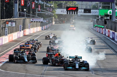 Lewis Hamilton (GBR) Mercedes AMG F1 W12 locks up under braking at the restart of the race while attempting to pass Sergio Perez (MEX) Red Bull Racing RB16B.