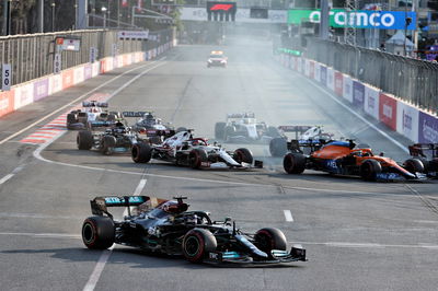 Lewis Hamilton (GBR) Mercedes AMG F1 W12 locks up under braking and runs wide at the restart of the race while attempting to pass Sergio Perez (MEX) Red Bull Racing RB16B.