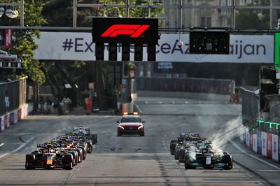 (L to R): Sergio Perez (MEX) Red Bull Racing RB16B and Lewis Hamilton (GBR) Mercedes AMG F1 W12 at the restart of the race.