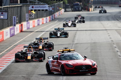 Max Verstappen (NLD) Red Bull Racing RB16B leads behind the Mercedes FIA Safety Car.