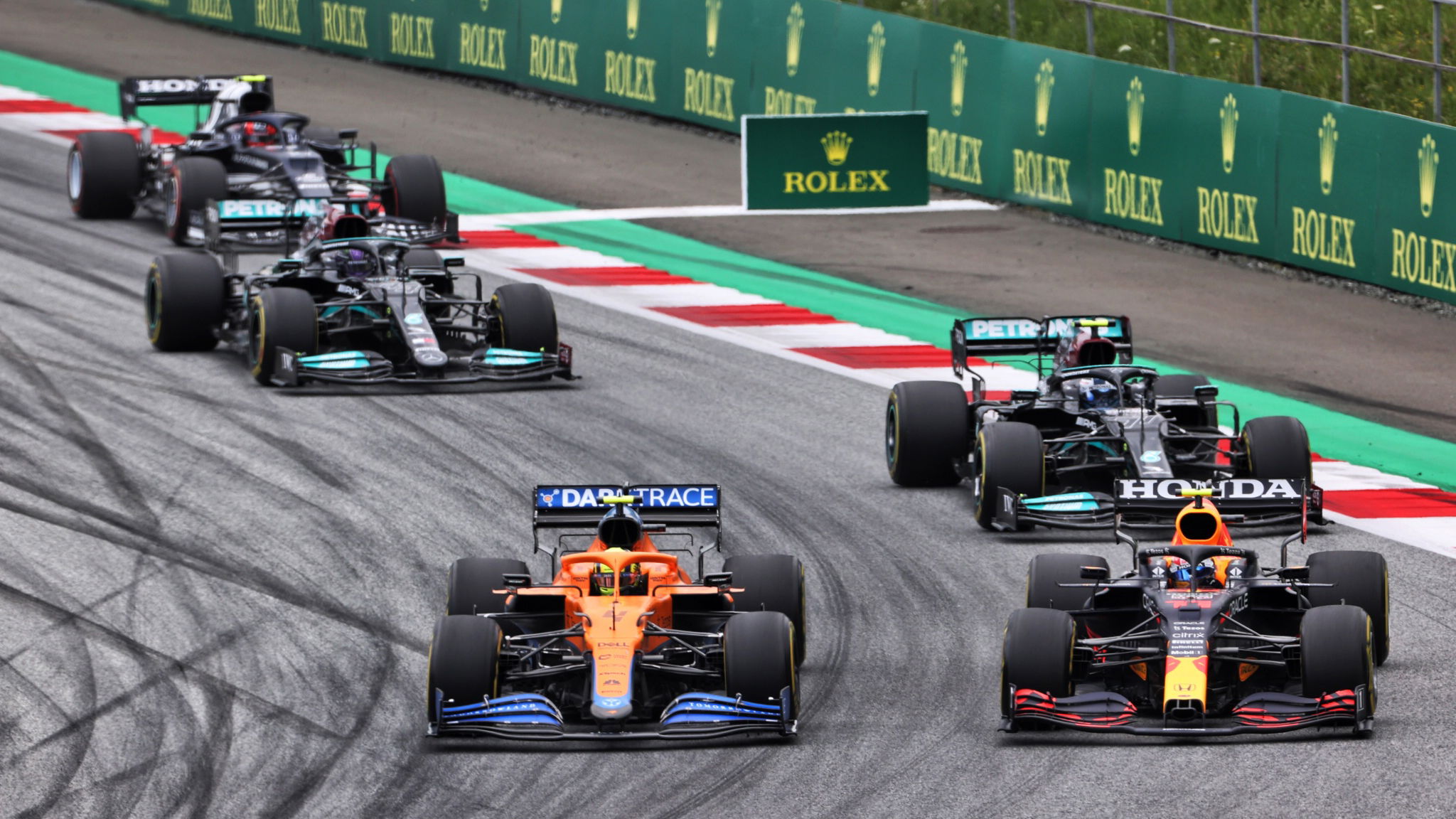 Lando Norris (GBR) McLaren MCL35M and Sergio Perez (MEX) Red Bull Racing RB16B battle for position.