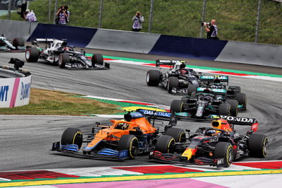 Lando Norris (GBR) McLaren MCL35M and Sergio Perez (MEX) Red Bull Racing RB16B battle for position.