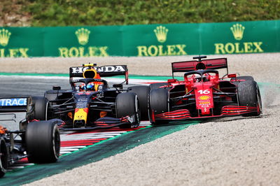 Sergio Perez (MEX) Red Bull Racing RB16B and Charles Leclerc (MON) Ferrari SF-21 battle for position.