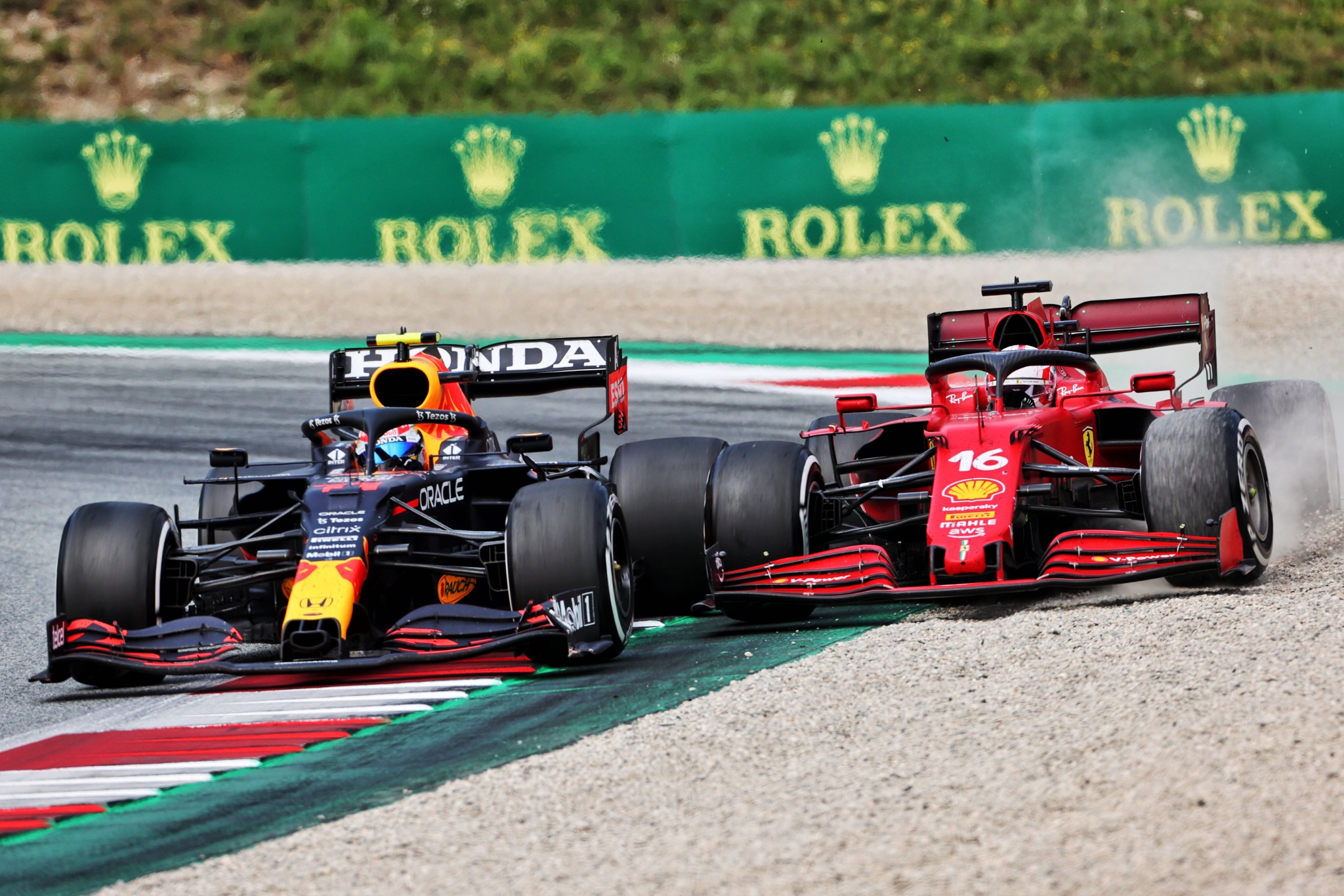 Sergio Perez (MEX) Red Bull Racing RB16B and Charles Leclerc (MON) Ferrari SF-21 battle for position.