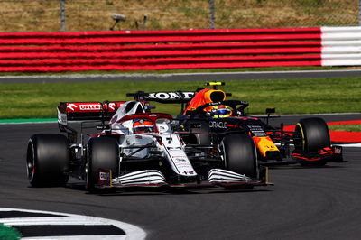 Kimi Raikkonen (FIN) Alfa Romeo Racing C41 and Sergio Perez (MEX) Red Bull Racing RB16B battle for position.