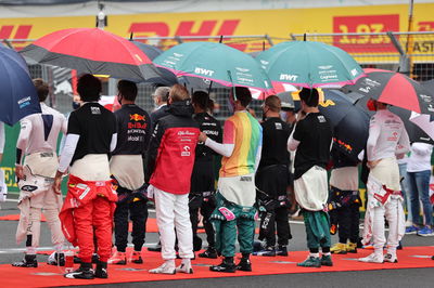 Sebastian Vettel (GER) Aston Martin F1 Team wearing a rainbow t-shirt as the grid observes the national anthem.