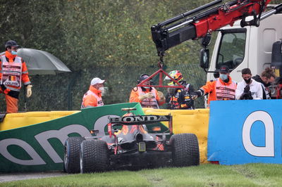 The Red Bull Racing RB16B of Sergio Perez (MEX) is craned away from the circuit after he crashed heading to the grid.