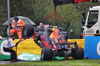 The Red Bull Racing RB16B of Sergio Perez (MEX) is craned away from the circuit after he crashed heading to the grid.