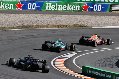 Max Verstappen (NLD) Red Bull Racing RB16B leads Sebastian Vettel (GER) Aston Martin F1 Team AMR21 and Lewis Hamilton (GBR) Mercedes AMG F1 W12.