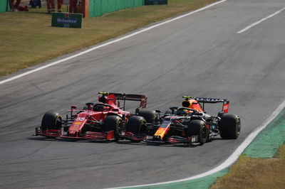 Carlos Sainz Jr (ESP) Ferrari SF-21 and Sergio Perez (MEX) Red Bull Racing RB16B.