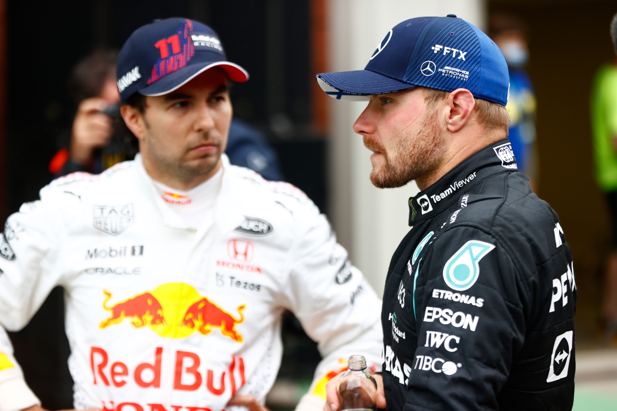 (L to R): Sergio Perez (MEX) Red Bull Racing with Valtteri Bottas (FIN) Mercedes AMG F1 in parc ferme.